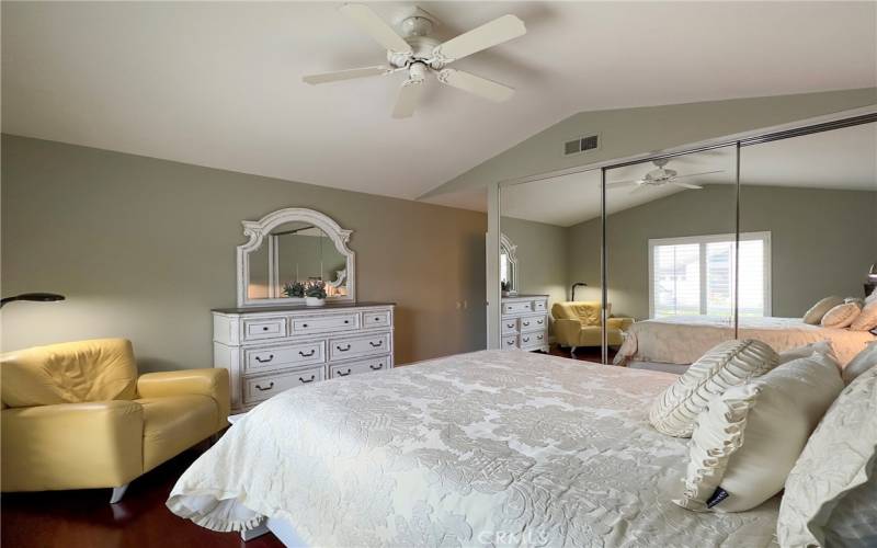 Master Bedroom with triple mirrored wardrobes and ceiling fans on vaulted ceilings.