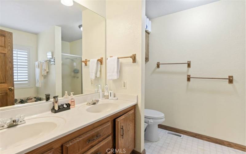 Primary bathroom w dual sinks and separate tub and shower in the mirro