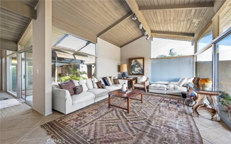 Open Family Room with lots of natural light and high wooden ceilings