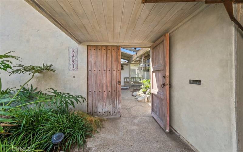Entrance way with antique door to your single level beach close mid century modern home.