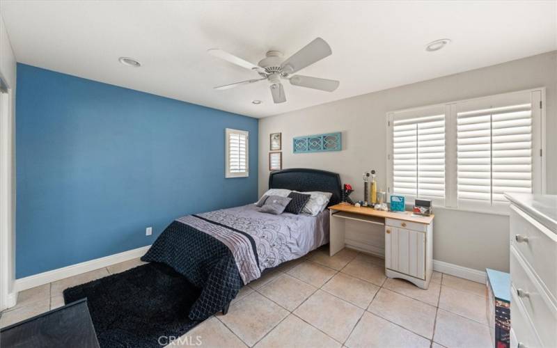 Generous sized secondary bedroom with shutters and ceiling fan