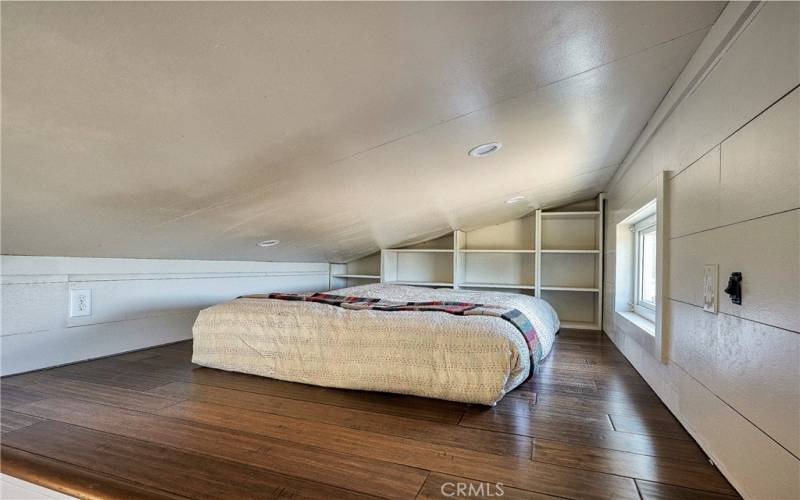 Loft area above fits a king bed & has movable bookshelves