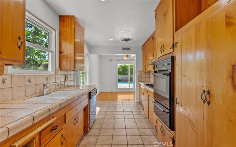Kitchen features a gas oven and range, a dishwasher, and a vented hood.