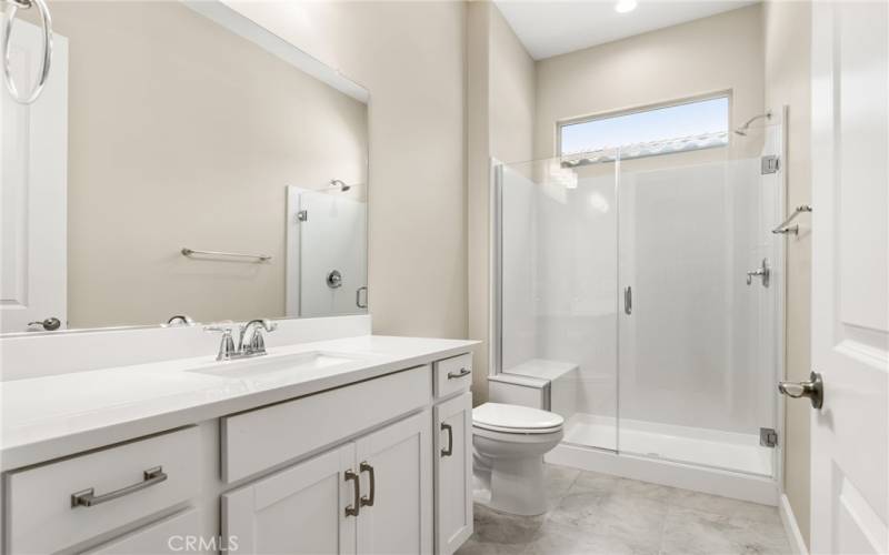 The guest bathroom features a walk in shower and lots of upgrades.