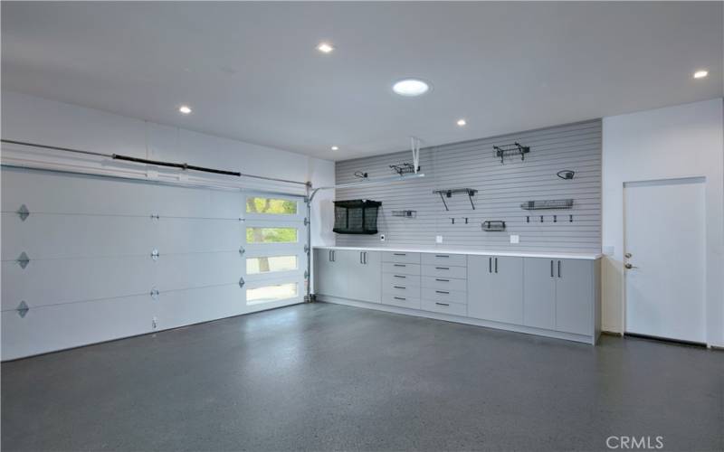 Garage with EV charging, epoxy floor and custom built ins