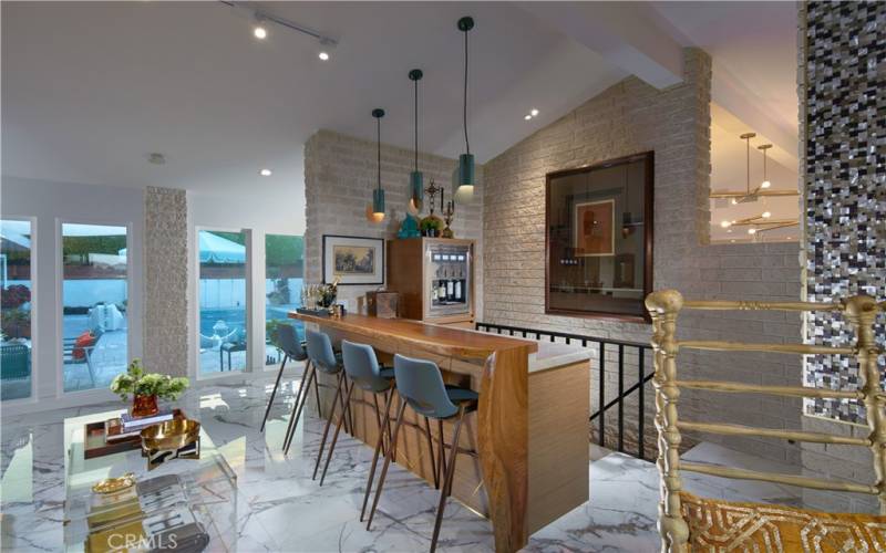 Family room with wine bar, stairs lead to 800 bottle subterranean wine cellar