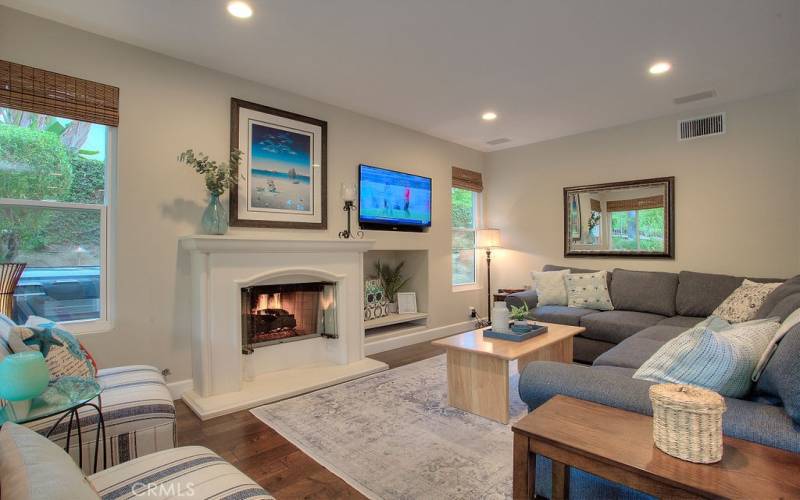 Beautiful wood floors and plenty of natural light flow throughout the home's open and airy layout.  Other special highlights include a charming gas fireplace.