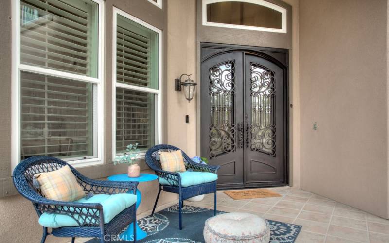 beautifully crafted double-door in the entry and charming front patio