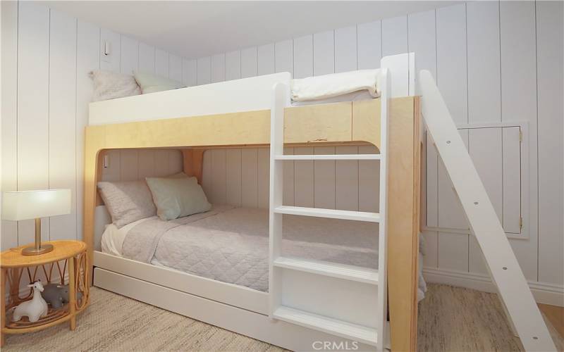 Den used as an additional bedroom with bunk beds