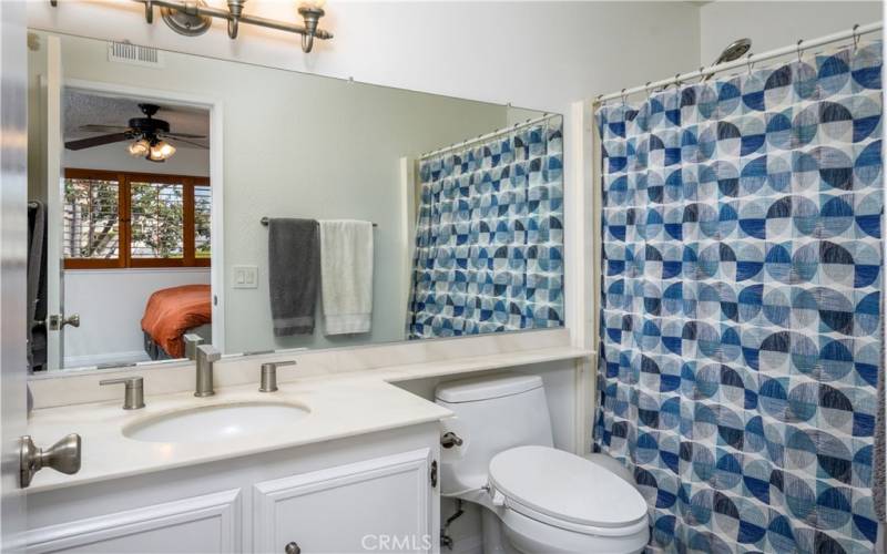Primary bathroom with a shower over tub.