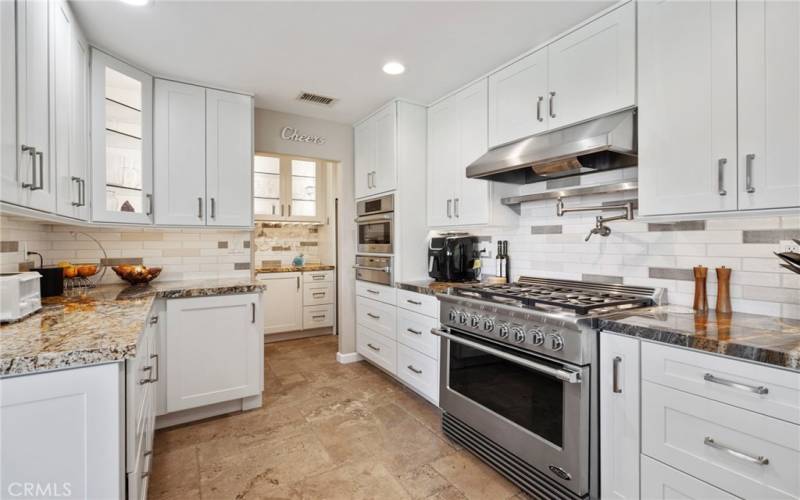 Beautiful, remodeled kitchen with Subzero Appliances, Pot Filler, Butler's Pantry, and Stone Countertops