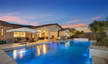 Twilight view of the large 7 ft deep salt water pool on 15,246 sq. ft. lot.