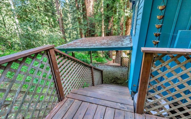 Steps off back deck, leading to laundry room