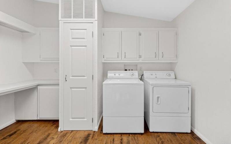Large laundry room with ample cabinet space.