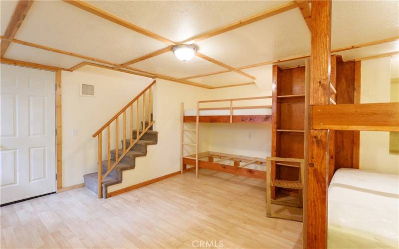 Lower level bonus space / Bunk room.  Door at bottom fo stairs leads to main basement/workshop space.