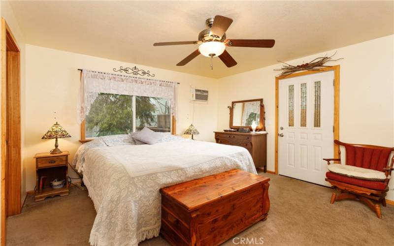 Primary bedroom with full Bath, walk-in closet, and entry to back deck/yard.