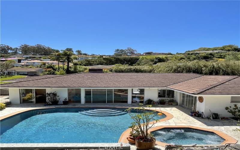 View of pool and house from top of hill