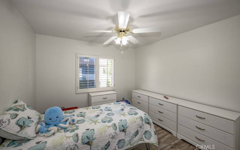 Home in Saugus CA bedroom, upstairs with ceiling fan and view of pool in backyard.