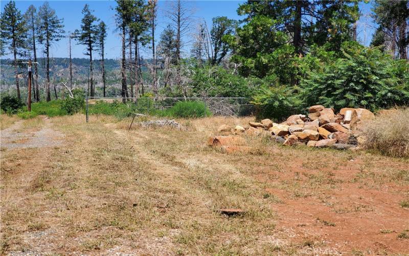 Property is behind the chain link fence