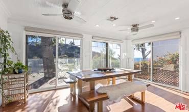 Dining area leading to deck with ocean and canyon views