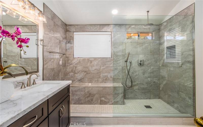 Master bathroom with huge glass shower with bench