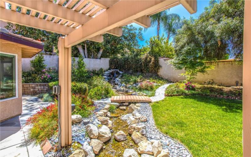 Beautiful waterfall feature with stream through backyard