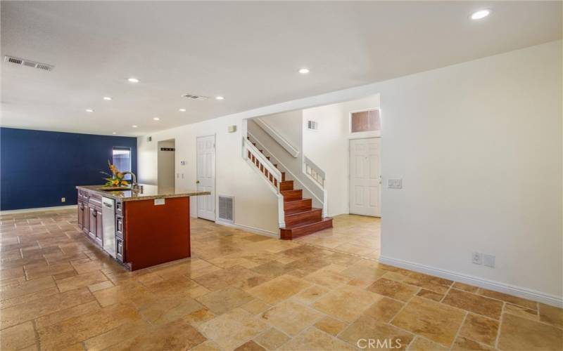 Family room view of kitchen and stairs and dining room