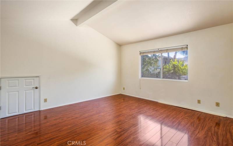 Master bedroom without staging- door to attic storage in master bedroom