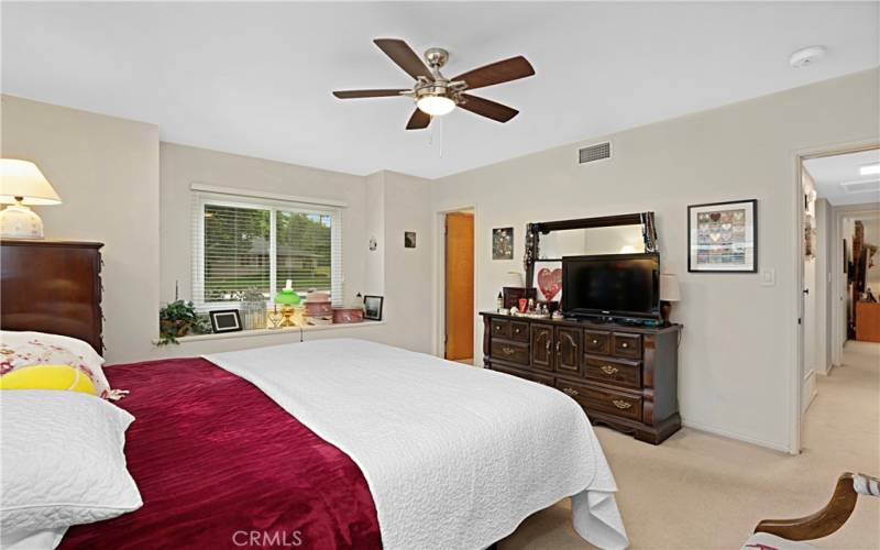 Main Bedroom: The window accent shelf offers a sitting area to read and enjoy neighborhood views. The door to the left goes into the main bathroom.