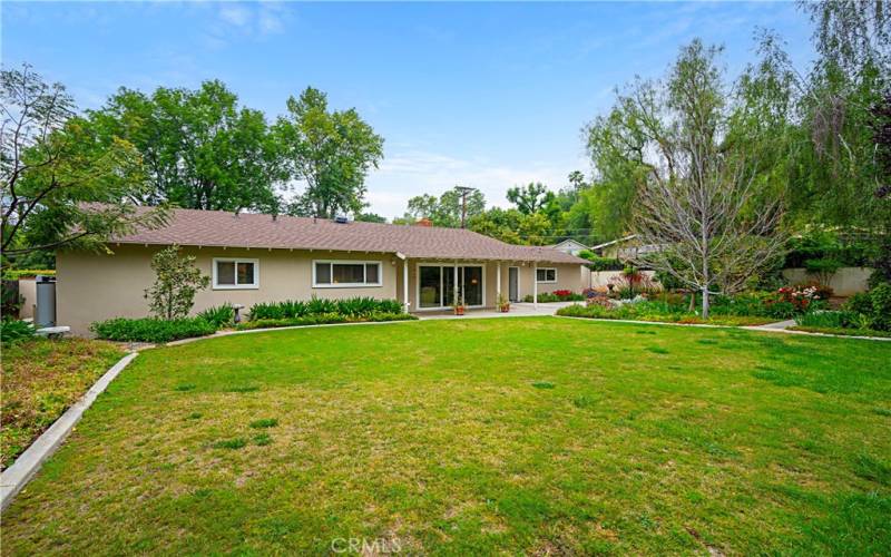 View of the back of the home from the corner of the yard.