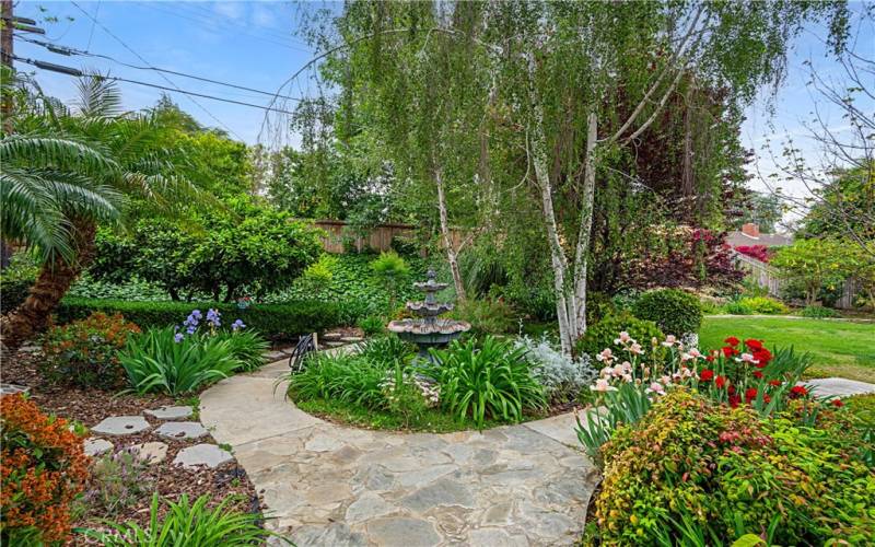 A fountain accents the main garden path