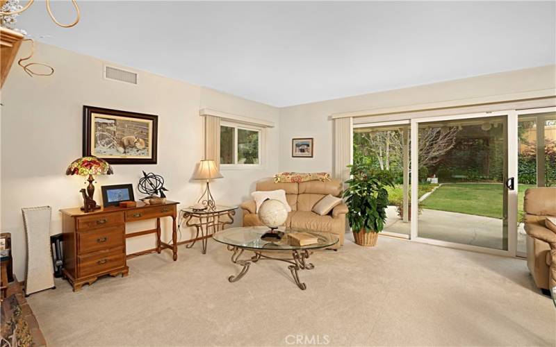 The sitting area in front of the brick fireplace hearth.