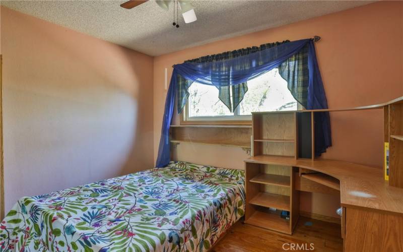 main floor bedroom with built in bed and desk