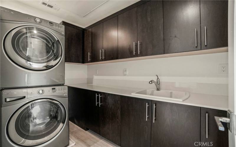 Laundry room with washer & dryer, sink, both upper and lower cabinets
