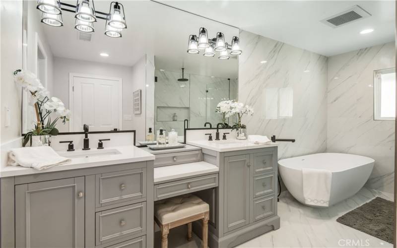 Primary bathroom vanity, two sinks, large soaking tub, large walk-in shower.