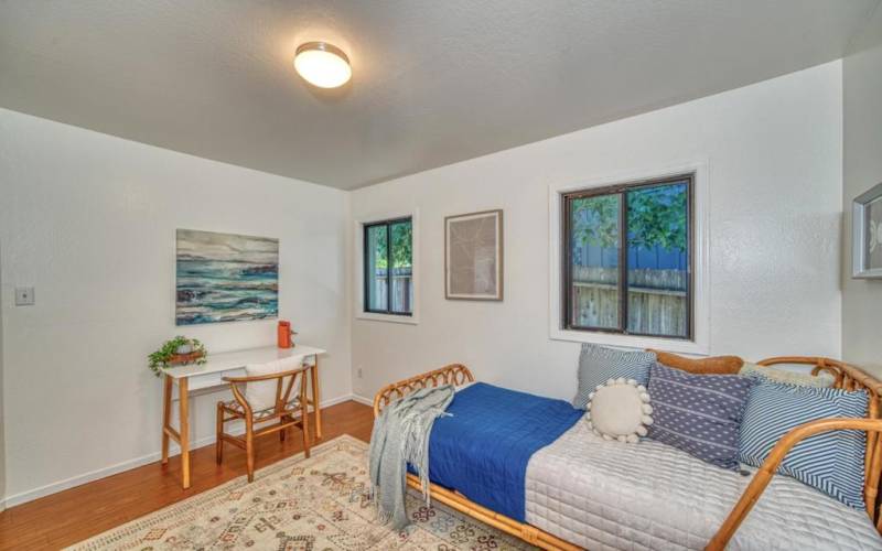 Primary bedroom has a lovely neighborhood view and is bright and cheerful.