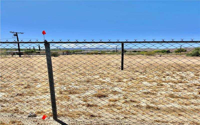 Note Flags and Pole in side fence for Approximate East side property boundary