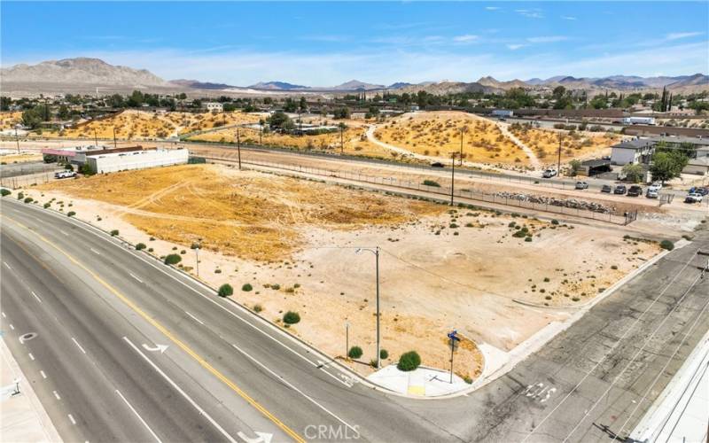 Intersection of Village and Calgo. Village is 5 lanes wide. Frontage is 180'. I-15 pictured in the background.