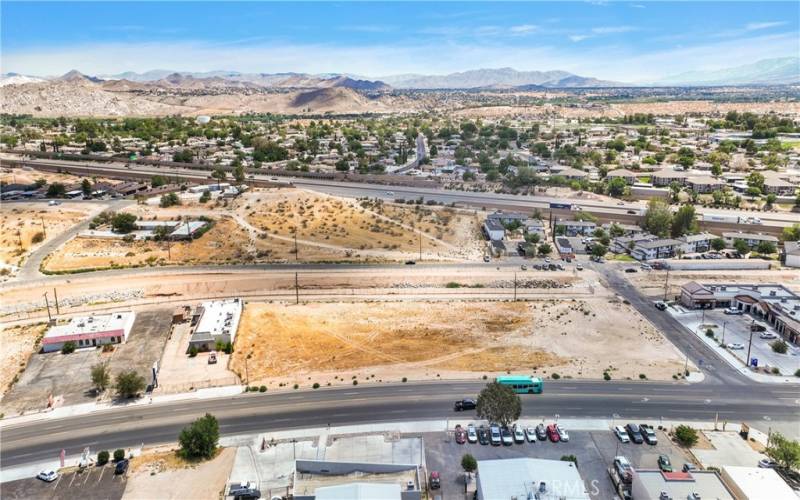 I-15 is visible in the rear of photo. Village, which is 5 lanes wide is the frontage for the property. The I-15 exit at Mojave is just S of this property. The three lots provide 180' of frontage on Village.