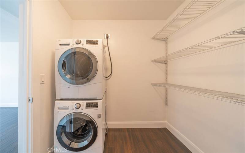 Washer and dryer tucked in the walk-in closet