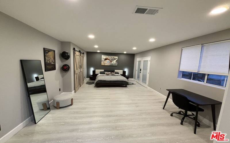 Spacious Master Bedroom with Doors Leading to Pool