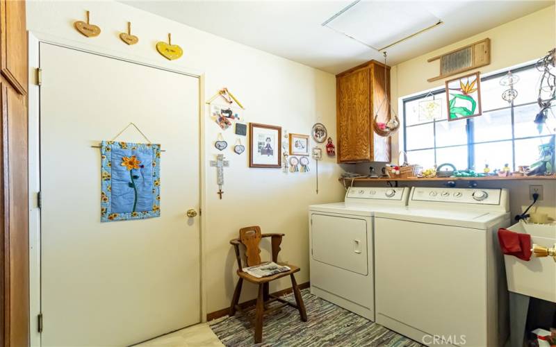 The laundry room with utility sink is located between the kitchen and garage.
