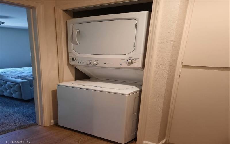 Washer and dryer, with linen closet to the right.