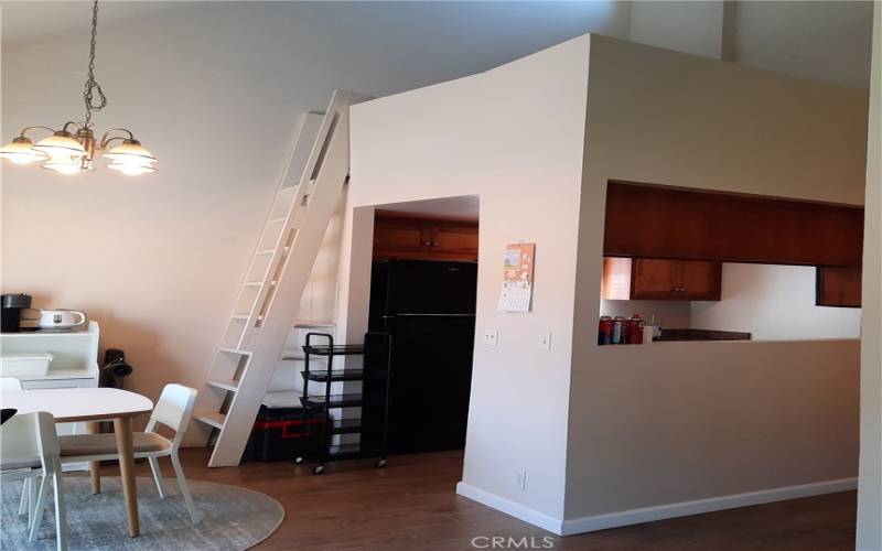 Stairs leading from dining area to loft over kitchen.