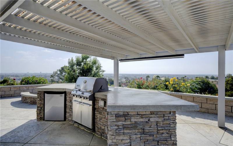 Spacious BBQ area with refrigerator and drawers for easy entertaining.
