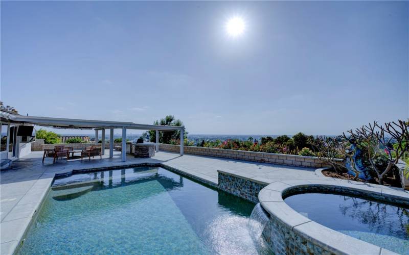 This unique pristine property has stunning 180 degree views day and night. Note the relaxing cascading waterfall from the spa to the pool.
