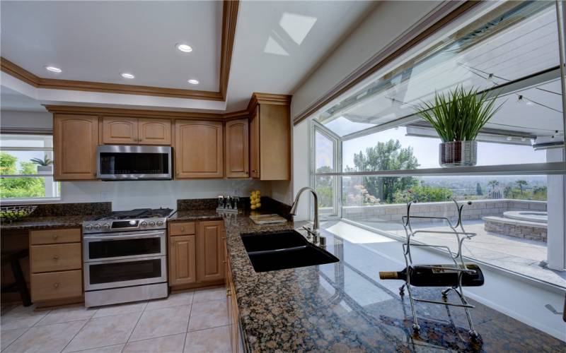 The kitchen has recessed lighting, dual sided sinks and a garden window with spectacular views.