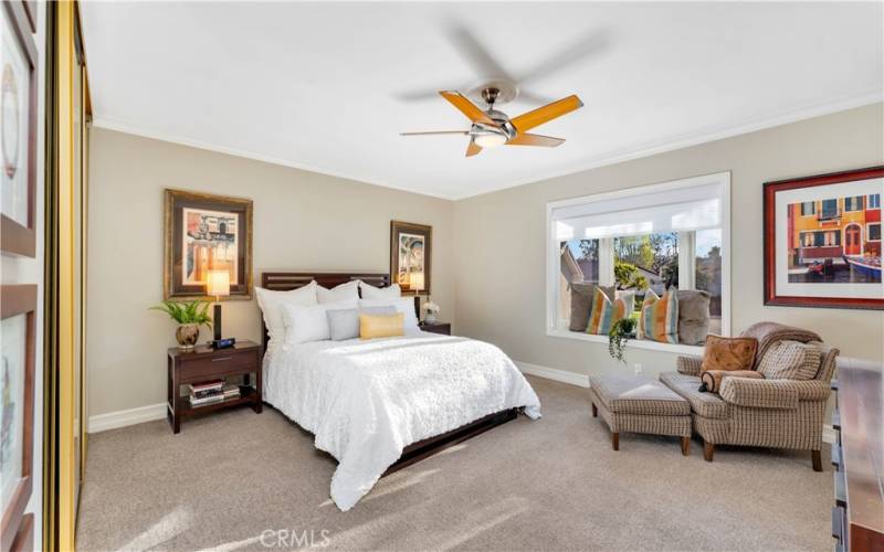 The master suite is spacious and comfortable. Newer carpet, crown molding and motorized shades finish the space.
