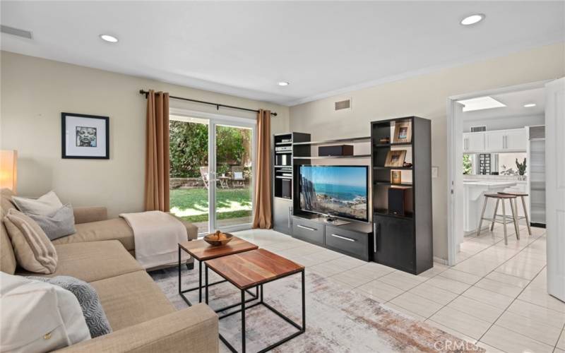 The kitchen flows to a spacious wet bar with wine storage, and a den that can be an ideal bonus or media room offers additional access to the backyard.