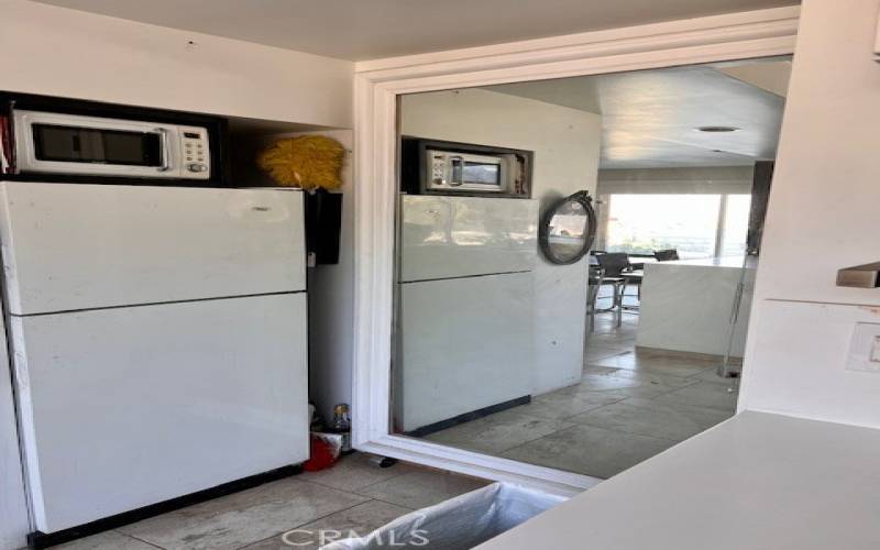 Kitchen behind mirror is water heater and newer furnace